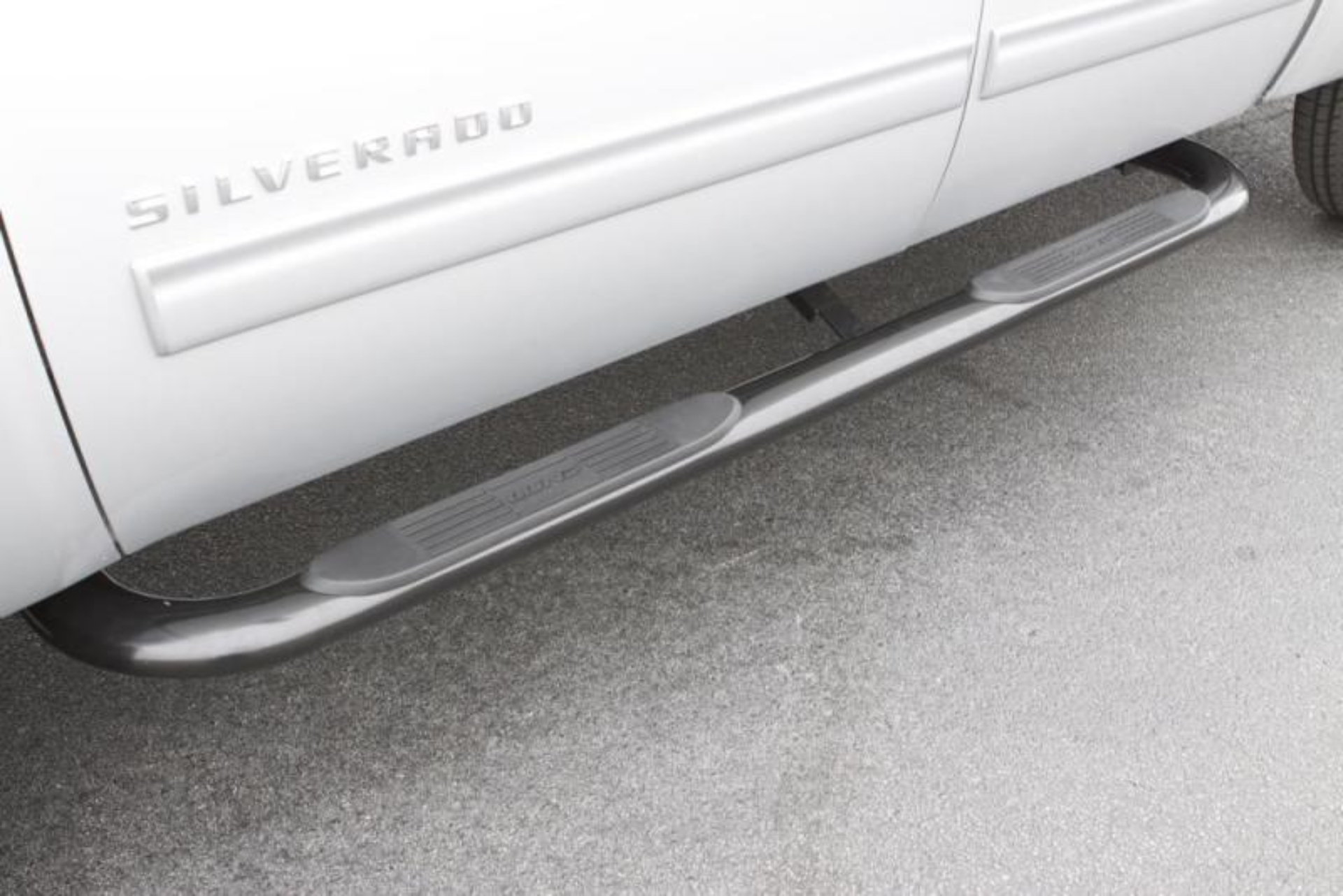 Picture of Lund 99-13 Chevy Silverado 1500 Ext. Cab (Body Mount) 4in. Oval Curved SS Nerf Bars - Polished