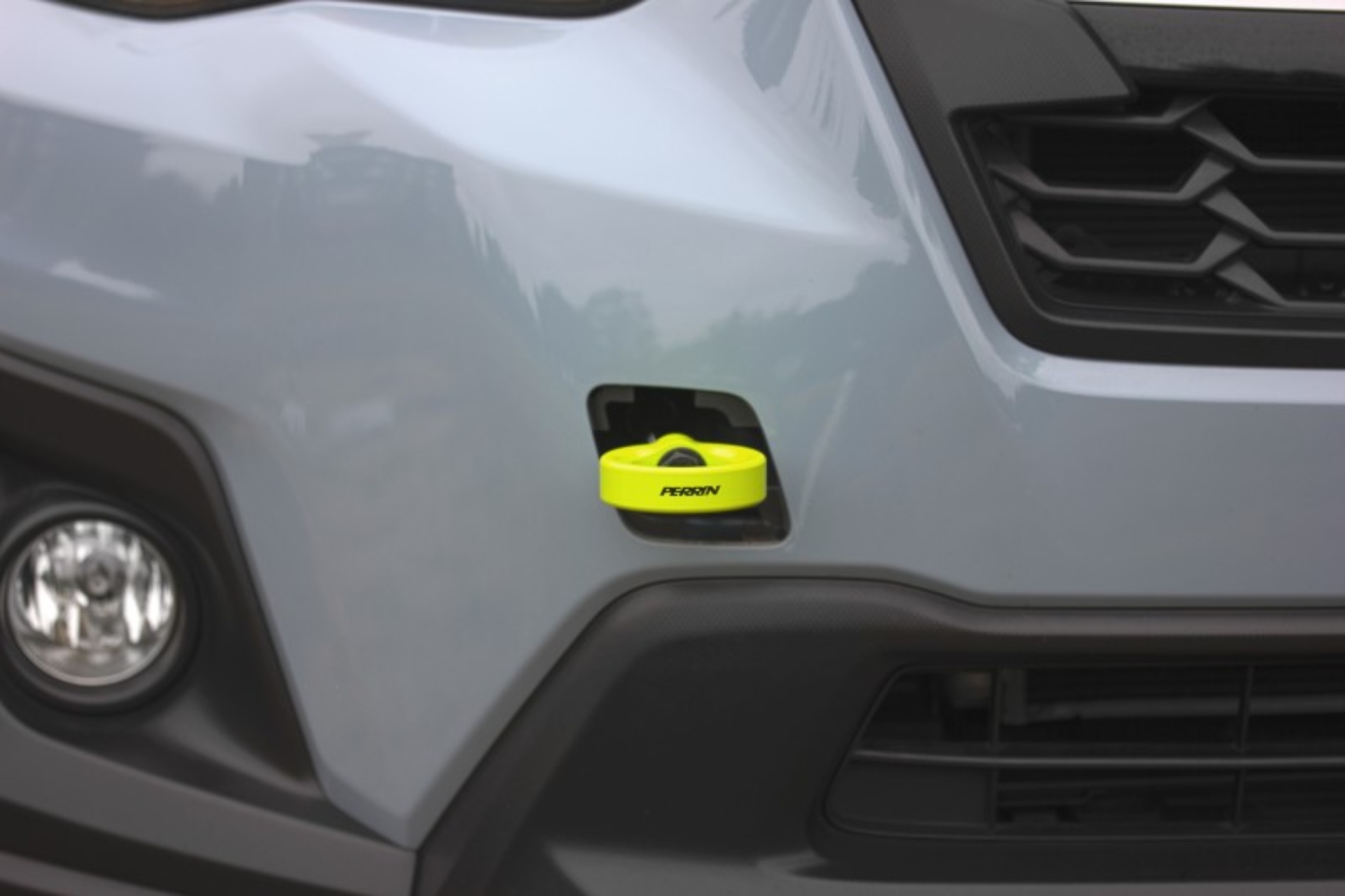 Picture of PERRIN 22-26 Subaru WRX / 18-23 Crosstrek / 20-25 OBXT Tow Hook Kit (Front) - Neon Yellow