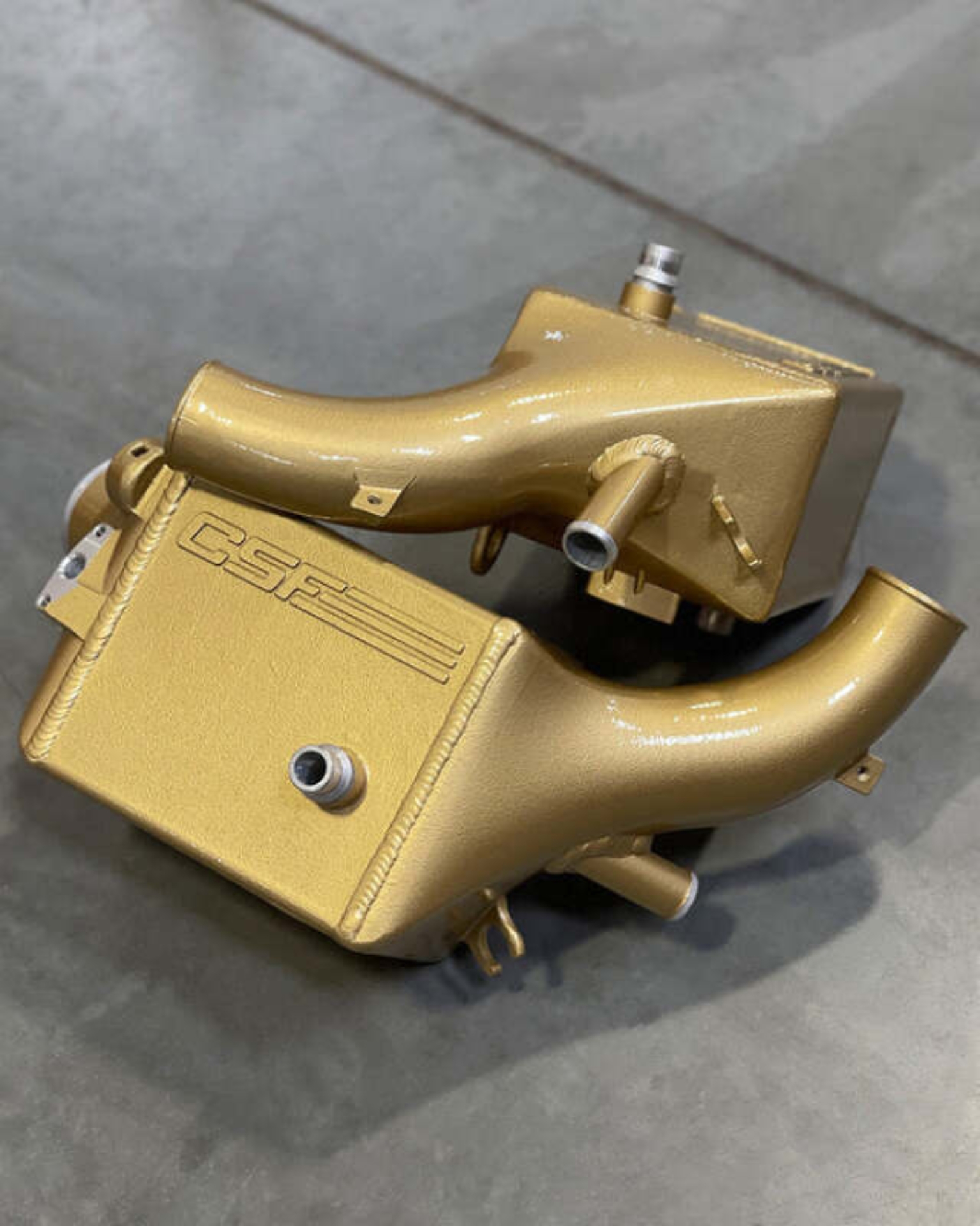 Picture of CSF 2025+ BMW G90 M5 / G99 M5 Touring Charge Air Cooler - Carbon Ceramic Gold Matte