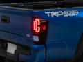 Picture of Raxiom 16-23 Toyota Tacoma XW Series Sequential LED Tail Lights- Black Housing- Red Lens